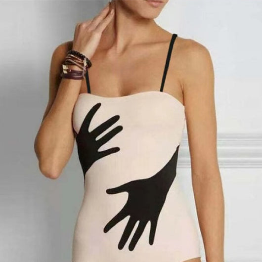 Women's light pink one-piece bikini with black handprint pattern and matching tie-waist sarong.