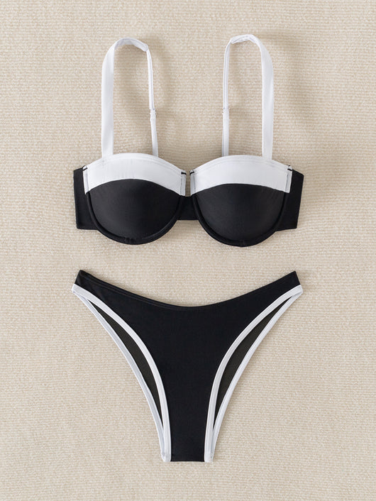 Black and white color block bikini with underwire top and high-cut bottoms, modeled by a woman by a pool. - Image 10
