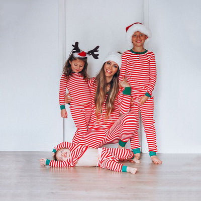 Family of six wearing matching red and white striped long-sleeved pajamas with green cuffs and festive hats. - Image 20