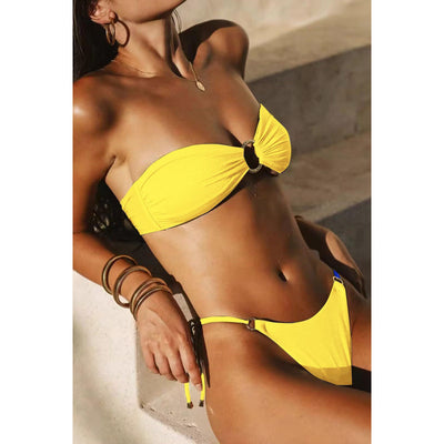 Red glitter bandeau bikini with gold-tone O-rings and side-tie bottoms on a model in a sunny outdoor setting. - Image 9