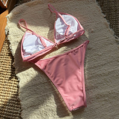 Woman wearing a black sequined triangle bikini top and high-cut bottom on a sunny beach. - Image 12