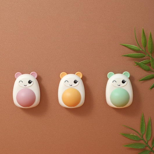 White and pink cartoon bear catnip toy with a winking face and a pink spinning ball on its belly. - Image 16