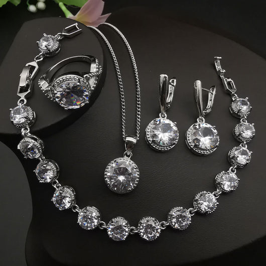 Four-piece silver-tone jewelry set with round green gemstones, including a necklace, bracelet, ring, and dangle earrings. - Image 12