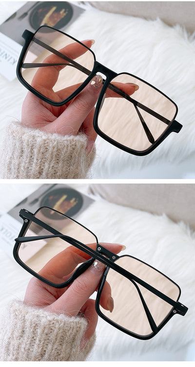 Retro square sunglasses with black frames and brown lenses held by a hand with patterned nails and a gold ring. - Image 10