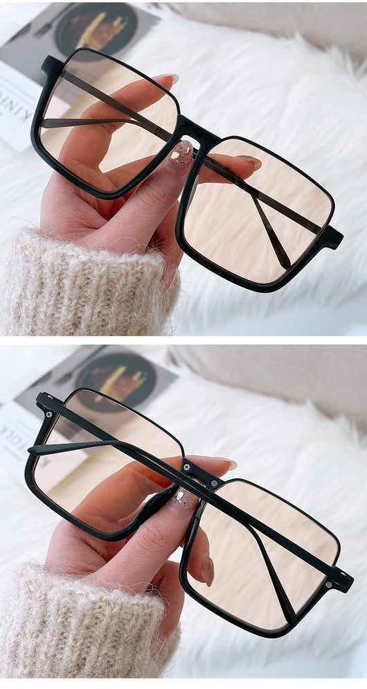 Retro square sunglasses with black frames and brown lenses held by a hand with patterned nails and a gold ring. - Image 10