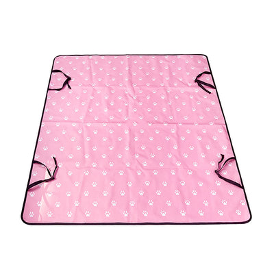 Pink car pet mat with white paw print and bone patterns, featuring black straps for securing to a rear seat. - Image 10
