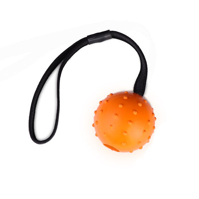 Red rubber dog training ball with nubs and a black rope handle, designed for bite resistance and molar cleaning. - Image 5