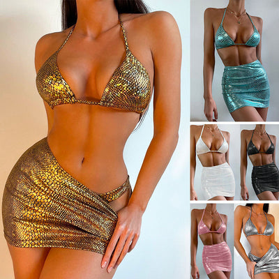 Woman wearing a black snake pattern halter bikini top and matching ruched mini skirt with a sheer cover-up.