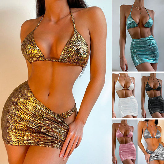 Woman wearing a black snake pattern halter bikini top and matching ruched mini skirt with a sheer cover-up.