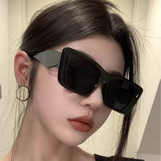Retro cat-eye sunglasses with a vibrant orange frame, brown temples, and light champagne-colored lenses. - Image 11