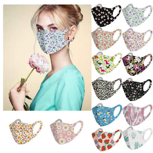 White face mask with a vibrant floral pattern featuring purple, blue, and pink flowers with green leaves.