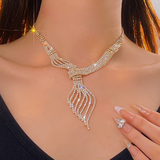 Gold-tone rhinestone necklace and matching dangle earrings set. The necklace features a multi-strand, leaf-like design. - Image 3