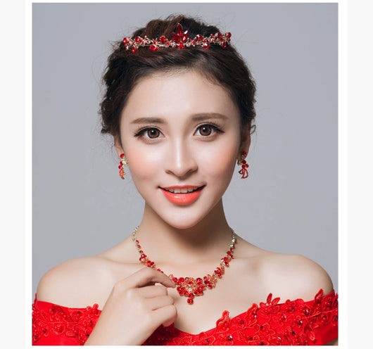 Red rhinestone bridal jewelry set featuring a floral necklace and matching dangle earrings on a model. - Image 10