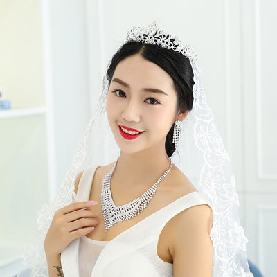 Sparkling rhinestone necklace and dangle earrings set. Large V-shaped bib necklace with claw chain design and matching long drop earrings.