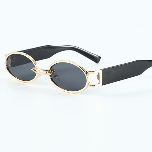 Retro small frame sunglasses with gold round frames and leopard print temples, held by a hand. - Image 2
