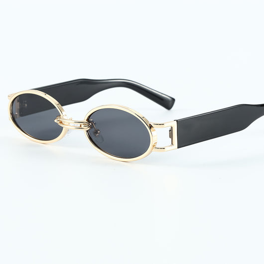 Retro small frame sunglasses with gold round frames and leopard print temples, held by a hand. - Image 2