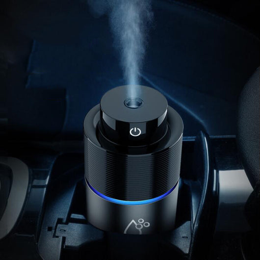 Silver-gray car humidifier and air purifier with a black top, emitting mist and glowing with a blue LED light. - Image 10