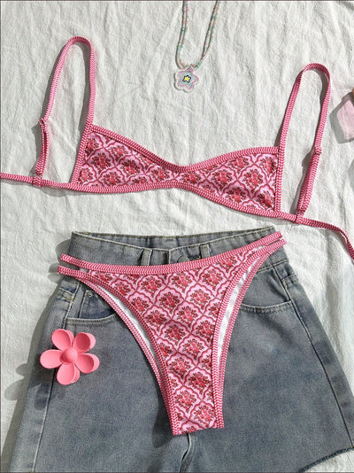 Black bandeau bikini swimsuit with thin straps and a gold-toned abstract ring detail on the top, paired with matching string bottoms. - Image 21