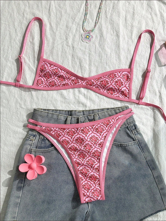 Black bandeau bikini swimsuit with thin straps and a gold-toned abstract ring detail on the top, paired with matching string bottoms. - Image 21