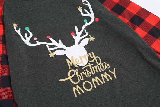 Woman wearing a Christmas pajama set with a dark gray 'Merry Christmas MOMMY' reindeer top and red and black plaid pants. - Image 19
