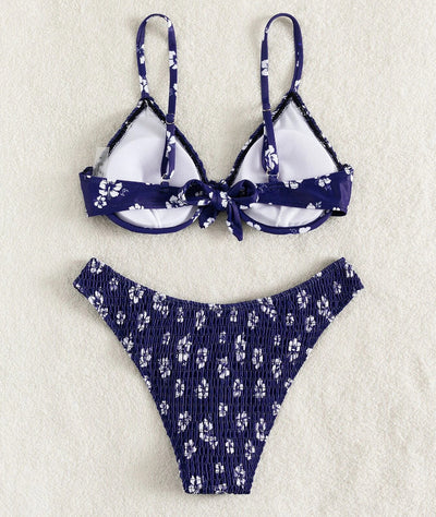 Periwinkle blue two-piece swimsuit with white floral pattern and ruched texture, featuring an underwire bikini top and high-cut bottoms. - Image 24