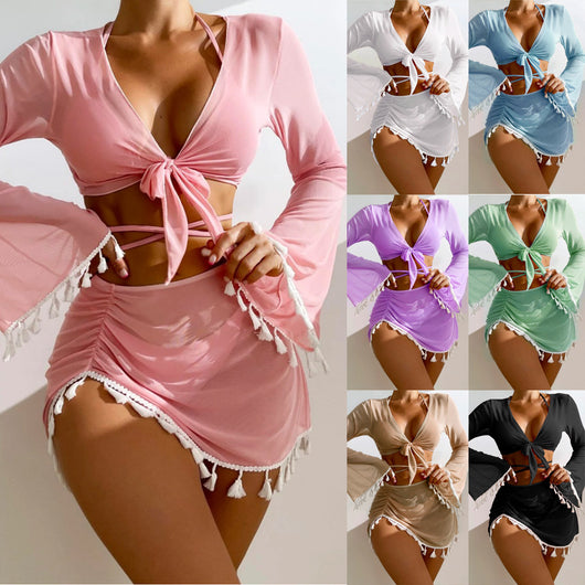 Light blue four-piece swimsuit set with a tie-front long-sleeve blouse, bikini top, and ruched mesh skirt with white tassels.
