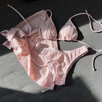 White textured bikini with ruched triangle top, high-cut bottom, and matching sarong with a large bow. - Image 13