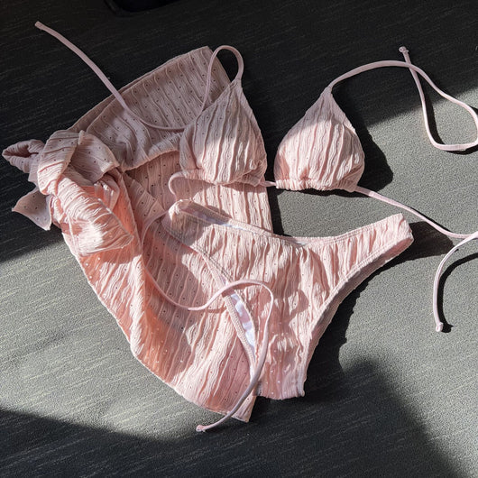 White textured bikini with ruched triangle top, high-cut bottom, and matching sarong with a large bow. - Image 13
