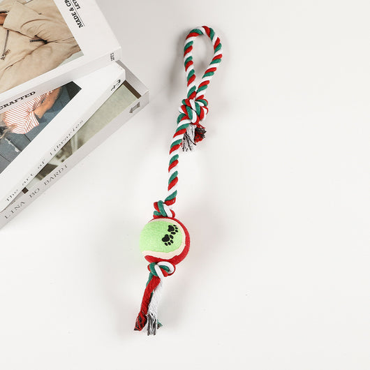 Red, pink, and white braided cotton rope dog toy with a green and red tennis ball featuring black paw prints. - Image 12