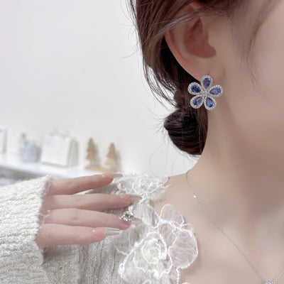 Elegant jewelry set with a silver-tone necklace and matching stud earrings, featuring blue and clear floral gemstones. - Image 11
