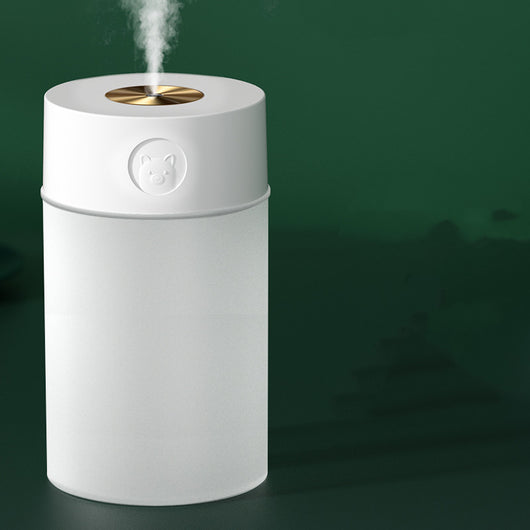 White cylindrical humidifier with a gold nozzle emitting mist, featuring a subtle bear emblem. Includes five aromatherapy oil bottles. - Image 5