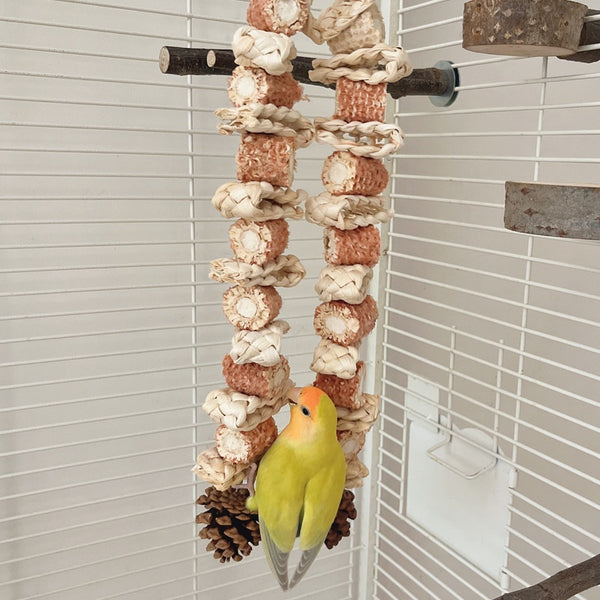 Colorful parrot bird toy with corn cobs, wood blocks, and pinecones, strung on rope with a metal hook, 50cm long.