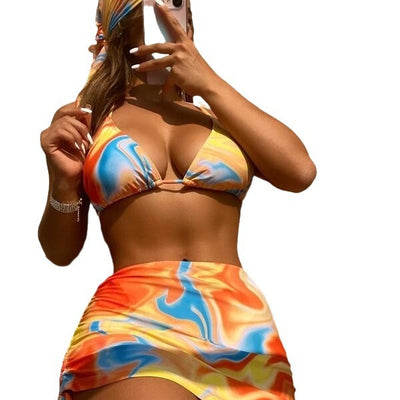Four-piece tie-dyed bikini swimsuit set in orange, yellow, and white, with a triangle top, high-cut bottoms, ruched mini skirt, and matching headscarf. - Image 5