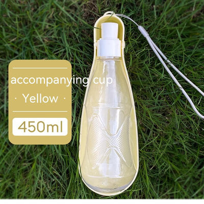 Yellow 450ml portable pet water bottle with a folding drinking trough and white wrist strap, on grass. - Image 11