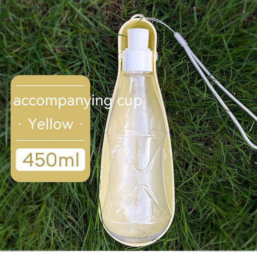 Yellow 450ml portable pet water bottle with a folding drinking trough and white wrist strap, on grass. - Image 11