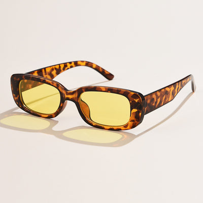 Rectangular tortoiseshell sunglasses with a small frame and dark gray lenses, angled on a white background. - Image 21