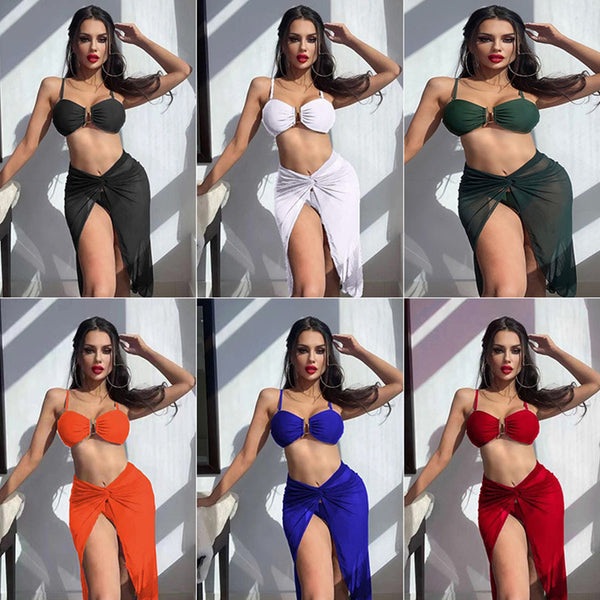 Bright green three-piece bikini set with a ruched bandeau top, matching bottoms, and a sheer knotted sarong skirt.
