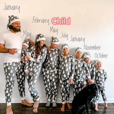 Family of seven and a dog in matching grey Christmas tree print pajamas with white cuffs and beanies. - Image 7