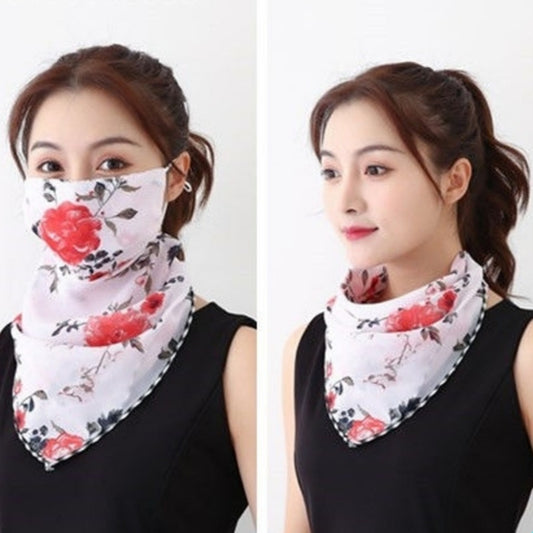 White women's UV protection scarf with black speckle pattern, worn as a face mask and neck scarf.