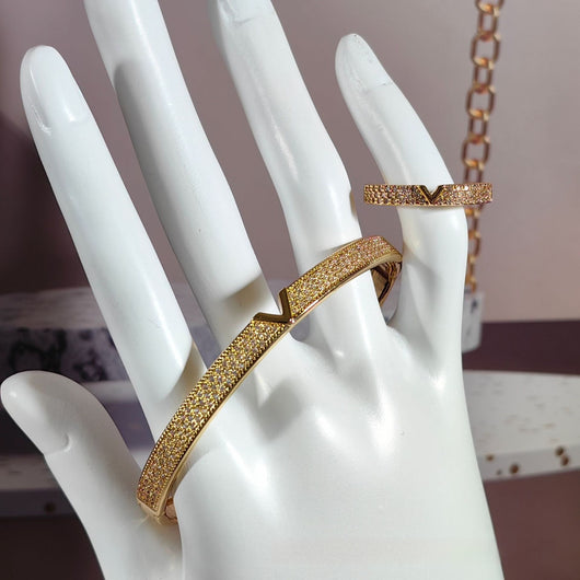 V-shaped 18K gold electroplated bracelet and ring set with pave clear stones on a white stand. - Image 4