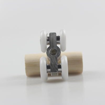 Wooden bird toy resembling a roller skate with a pine log body and four white wheels with metal bearings. - Image 3