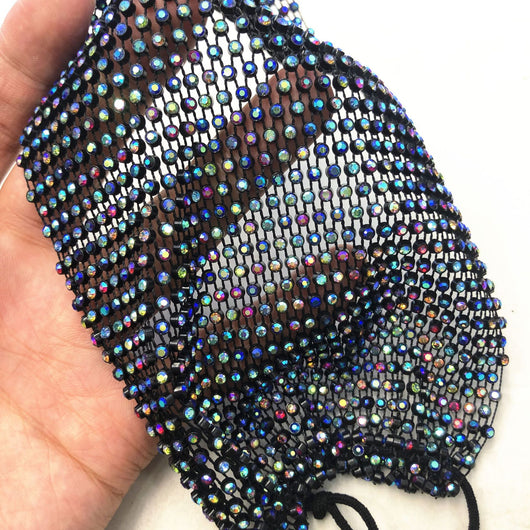 Close-up of a blue mesh fabric adorned with numerous small, clear rhinestones, creating a sparkling texture. - Image 58