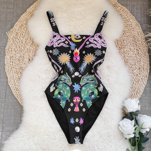 Black one-piece swimsuit for women featuring a vibrant multi-color print with dragons, suns, moons, and stars. - Image 7