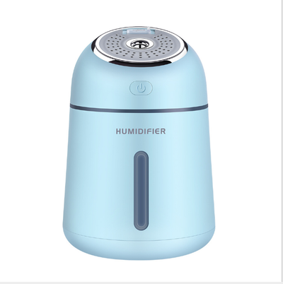 Light blue mini ultrasonic humidifier with a silver top, power button, and clear water level indicator. - Image 5