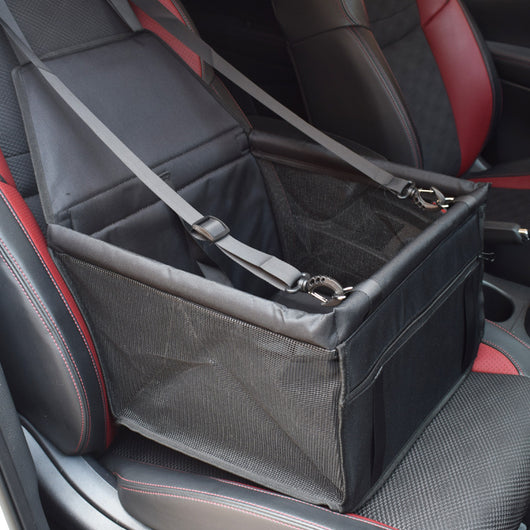 Light grey pet car booster seat with black mesh sides and adjustable straps, installed on a black and red car seat. - Image 5