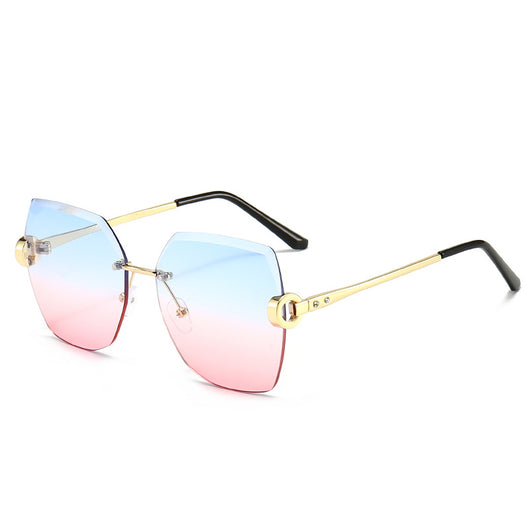 Woman wearing oversized hexagonal rimless sunglasses with gradient lenses and a black leather newsboy cap. - Image 7