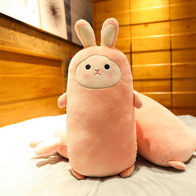 Pink rabbit plush doll with closed eyes, soft and elongated, standing on a bed. - Image 7