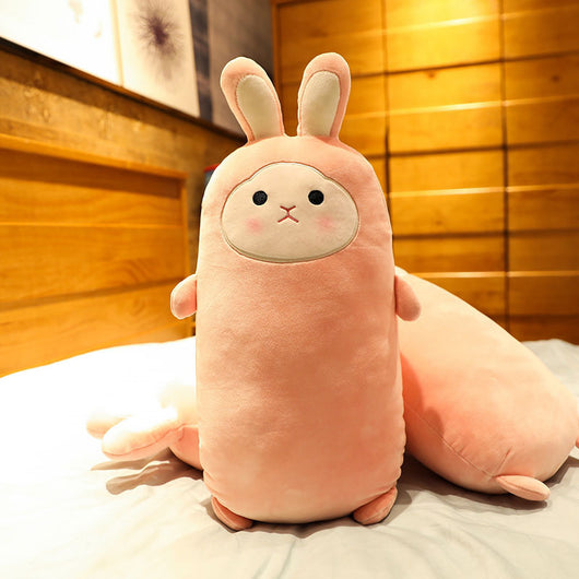 Pink rabbit plush doll with closed eyes, soft and elongated, standing on a bed. - Image 7