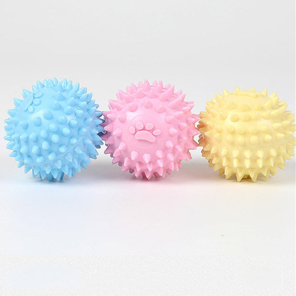 Yellow spiky pet toy ball with a paw print design, made from TPR for interactive play and molars.