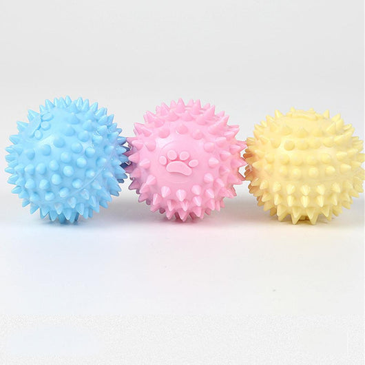 Yellow spiky pet toy ball with a paw print design, made from TPR for interactive play and molars.